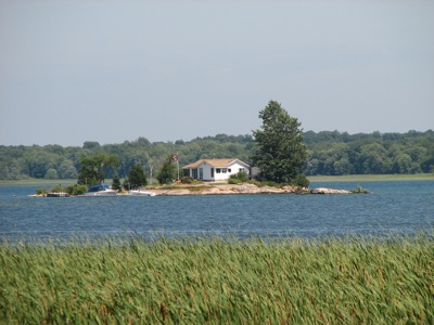 Private Island in the St. Lawrence River, as seen from 1000 Islands Parkway, Ontario, Canada.
